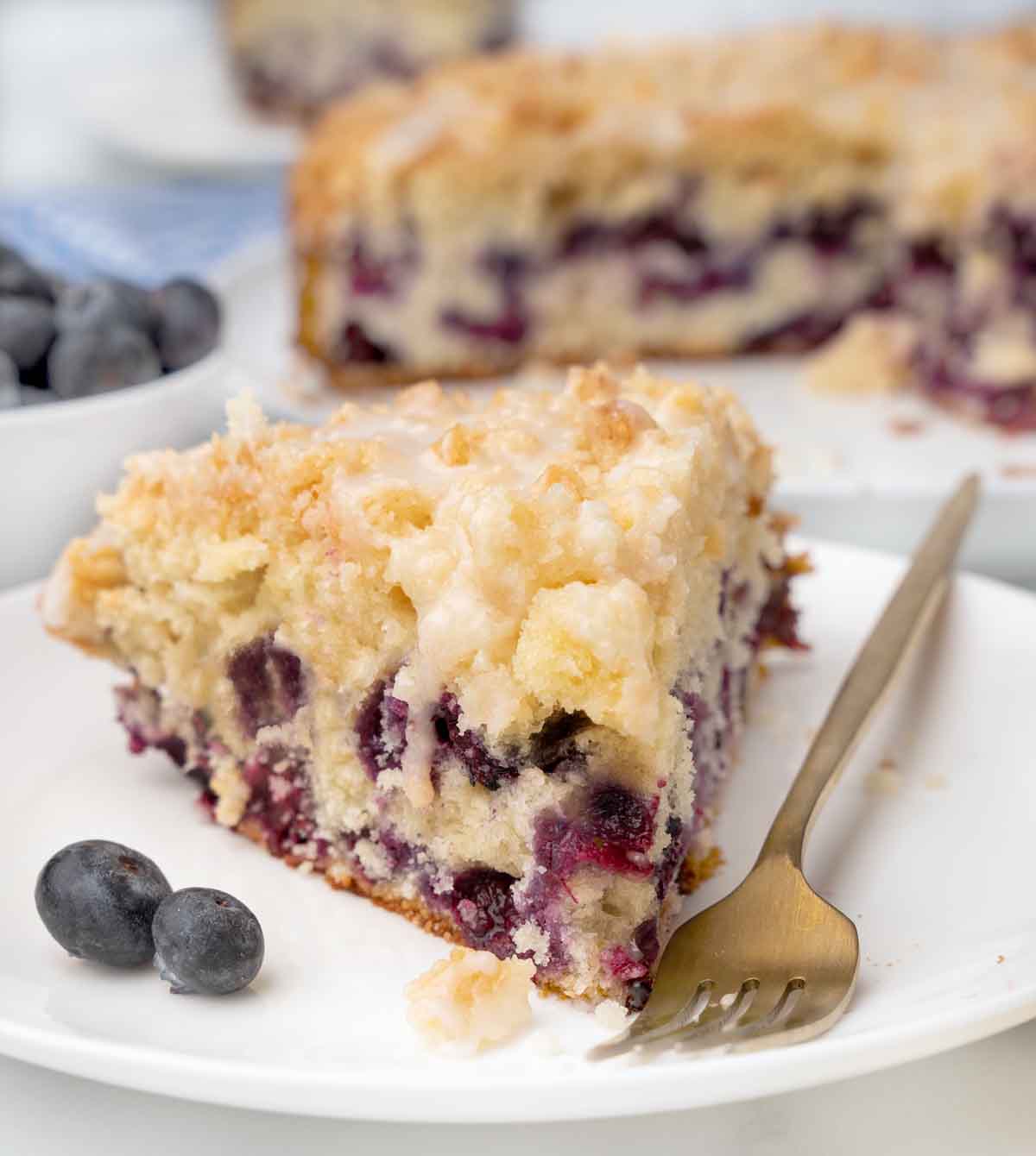 slice of blueberry coffee cake on white plate