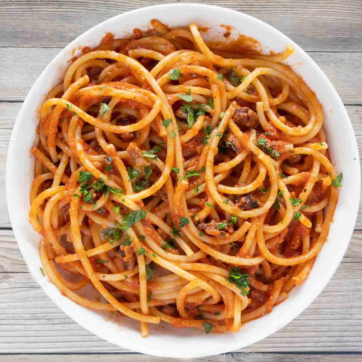 bucatini all' amatriciana in a white bowl