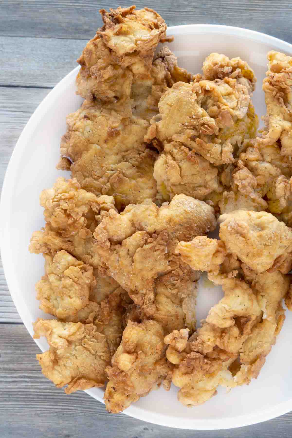 buttermilk fried chicken tenders on a white plate