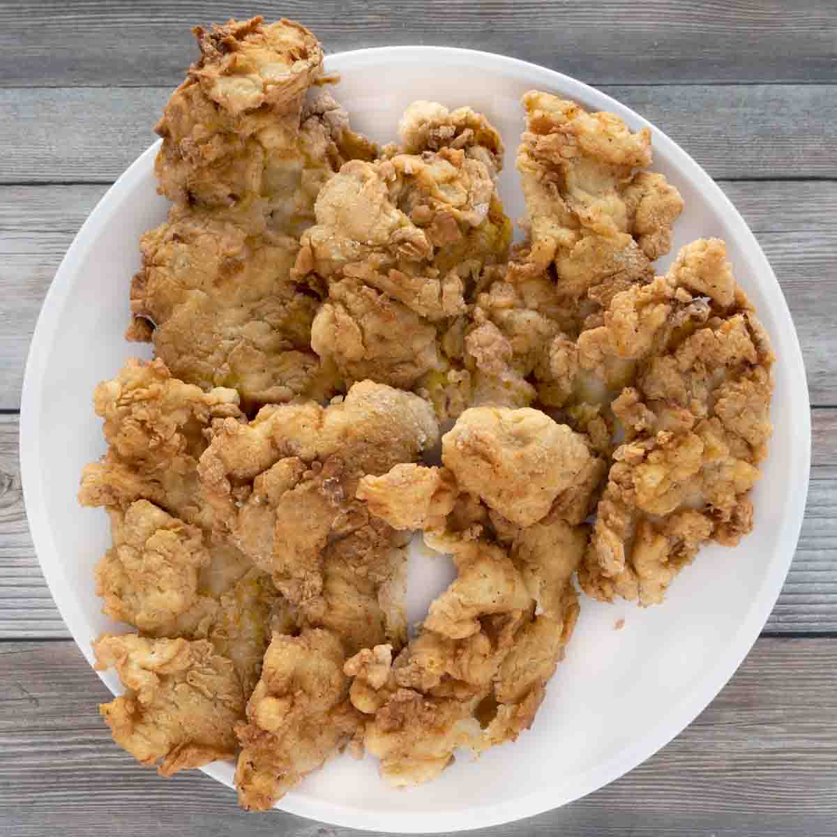 buttermilk fried chicken tenders on a white plate