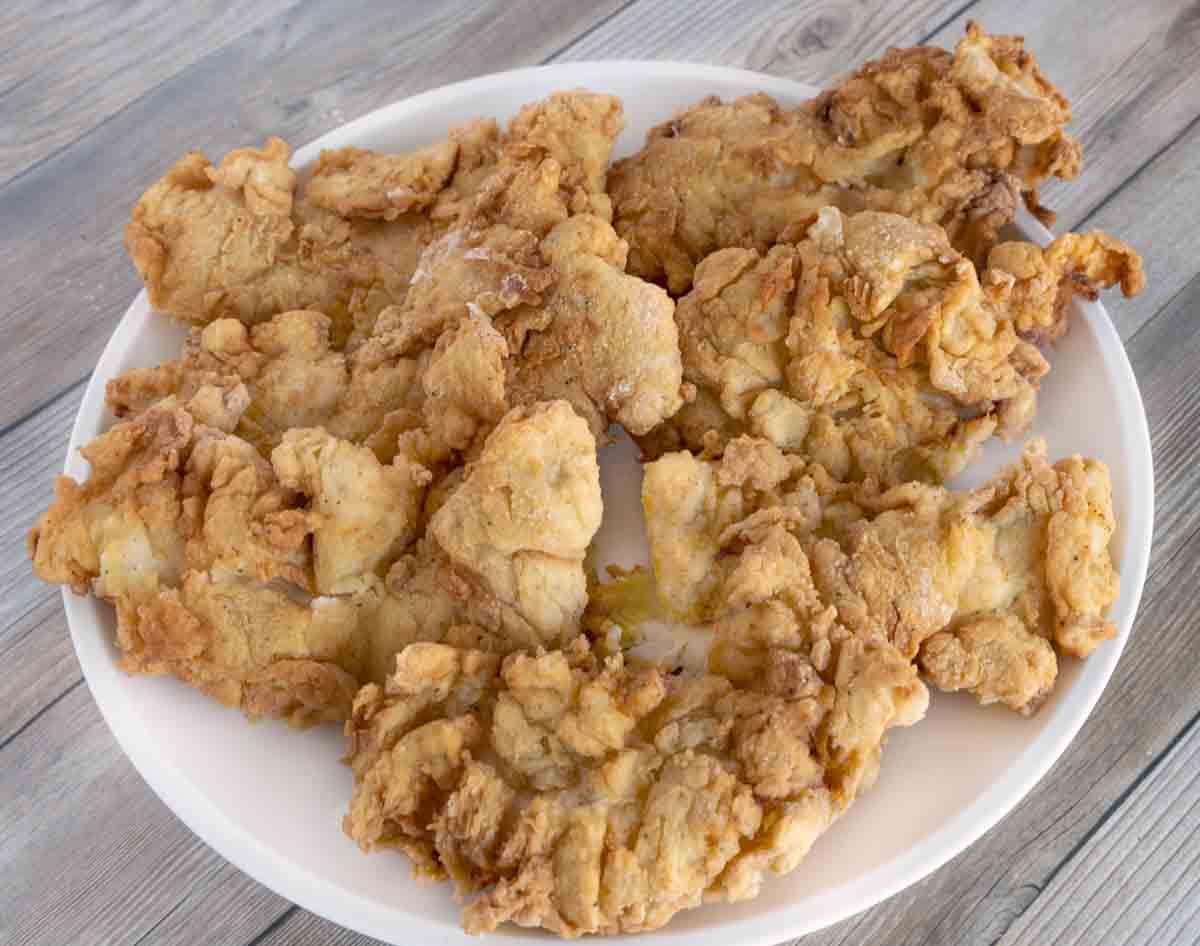 buttermilk fried chicken tenders on a white plate