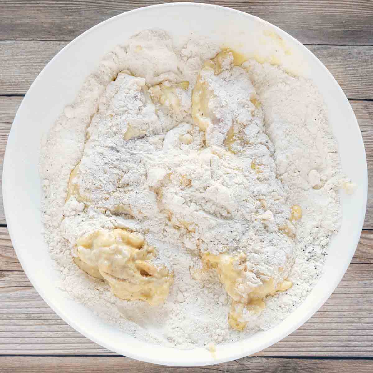 egg dipt chicken back into the white bowl with seasoned flour