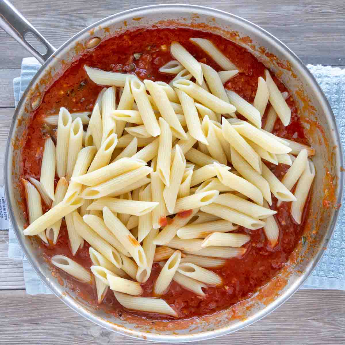 penne added to arrabbiata sauce