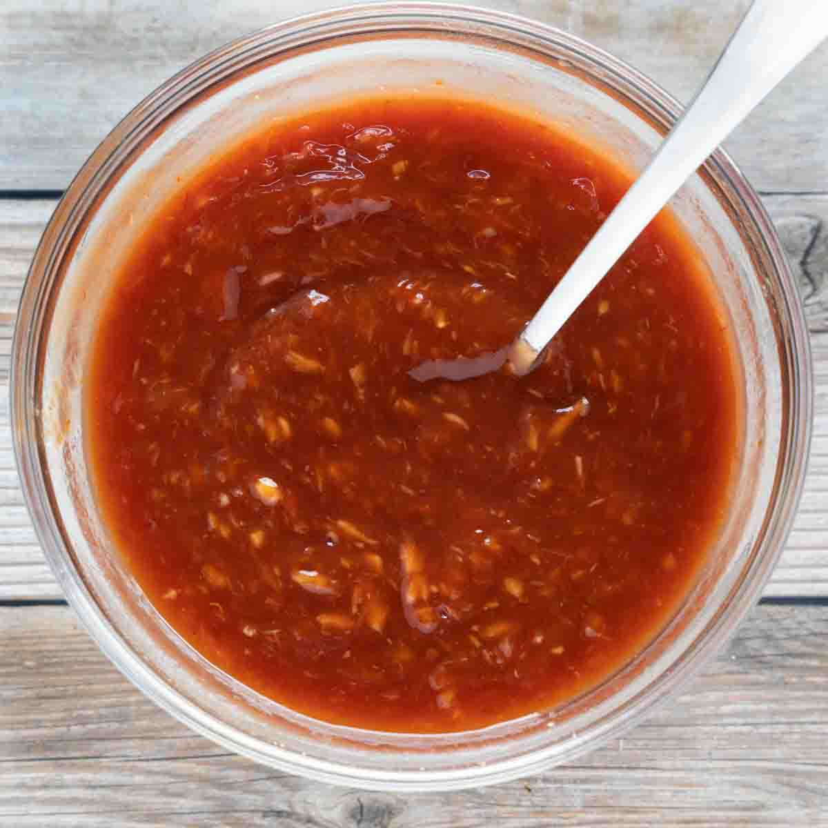 homemade cocktail sauce in a glass bowl with a spoon