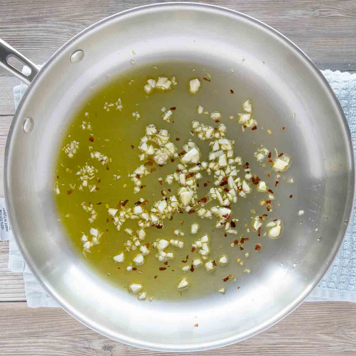 oil in skillet with fresh chopped garlic and red pepper flakes