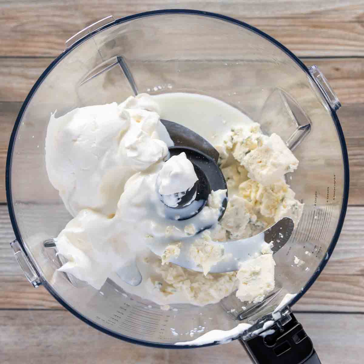 sour cream, bleu cheese and milk in the bowl of a food processor