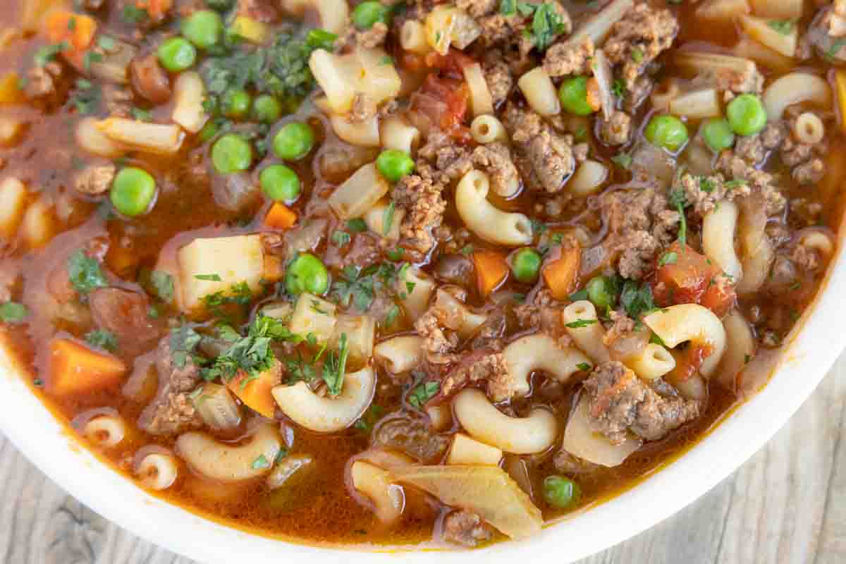 close up of hamburger soup in a white bowl