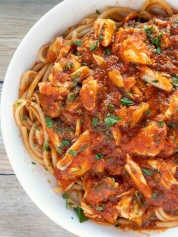 pasta with red crab sauce in a white bowl