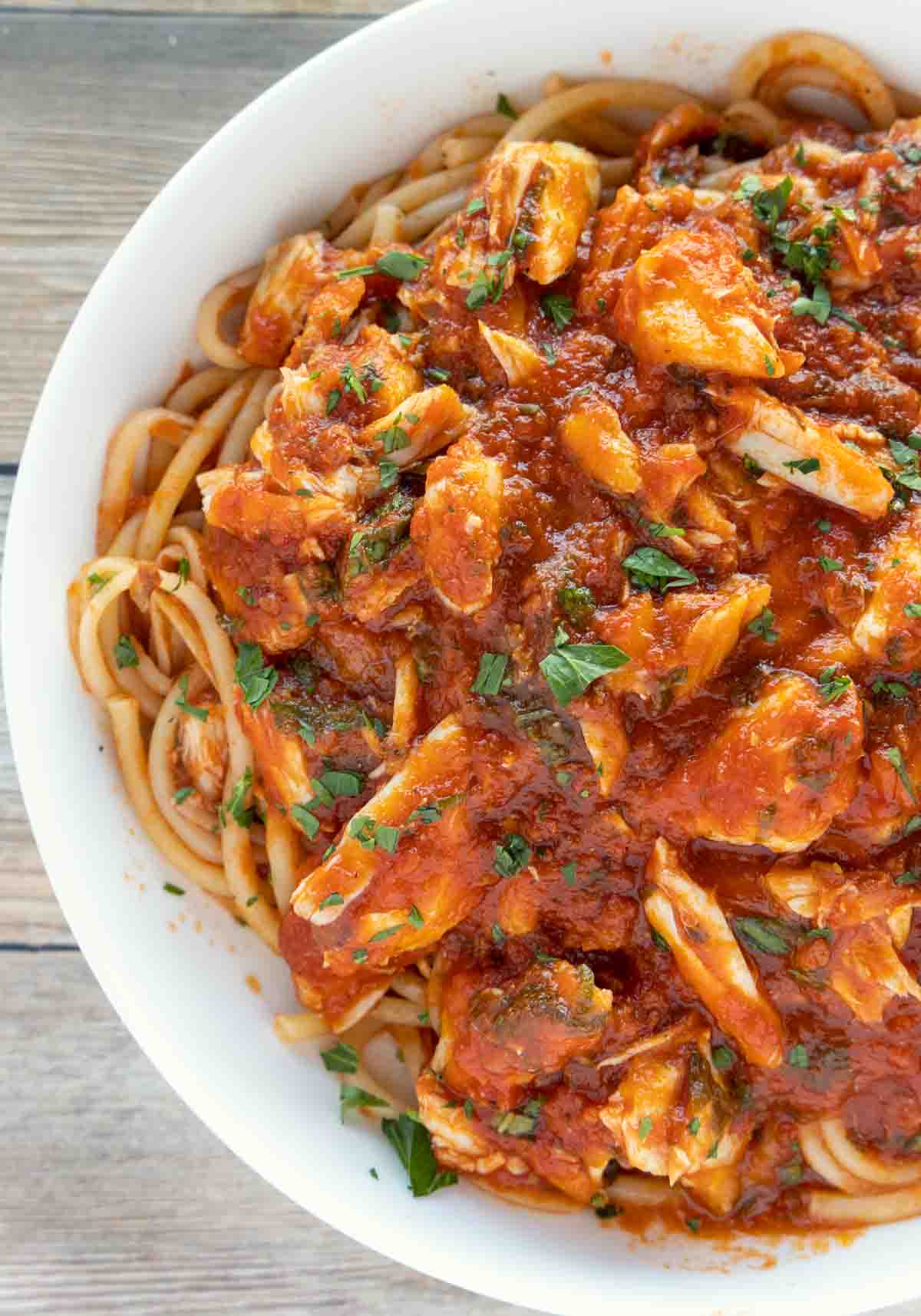 pasta with red crab sauce in a white bowl