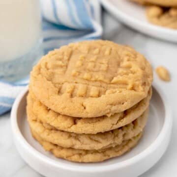 stack of peanut butter cookies on a white plate