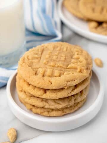 stack of peanut butter cookies on a white plate