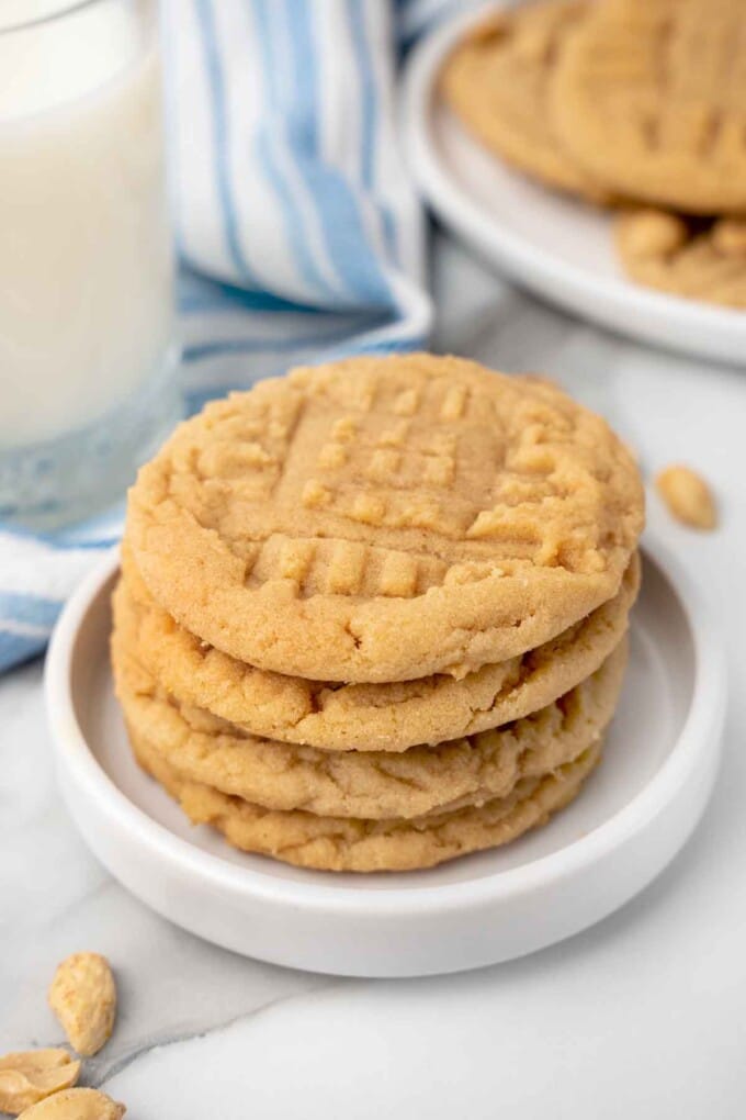 stack of peanut butter cookies on a white plate