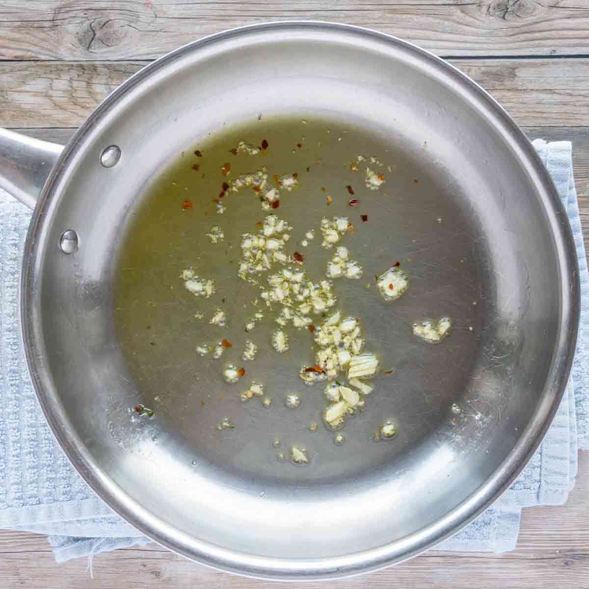 sauté garlic and red pepper flakes in a skillet.