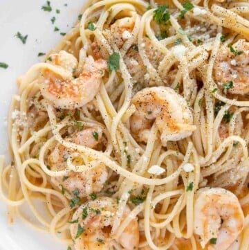 shrimp scampi with linguini on white plate