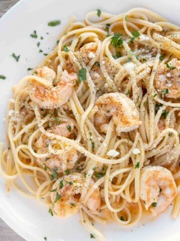 shrimp scampi with linguini on white plate