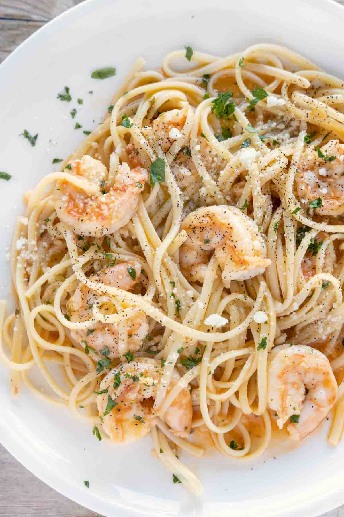 shrimp scampi with linguini on white plate