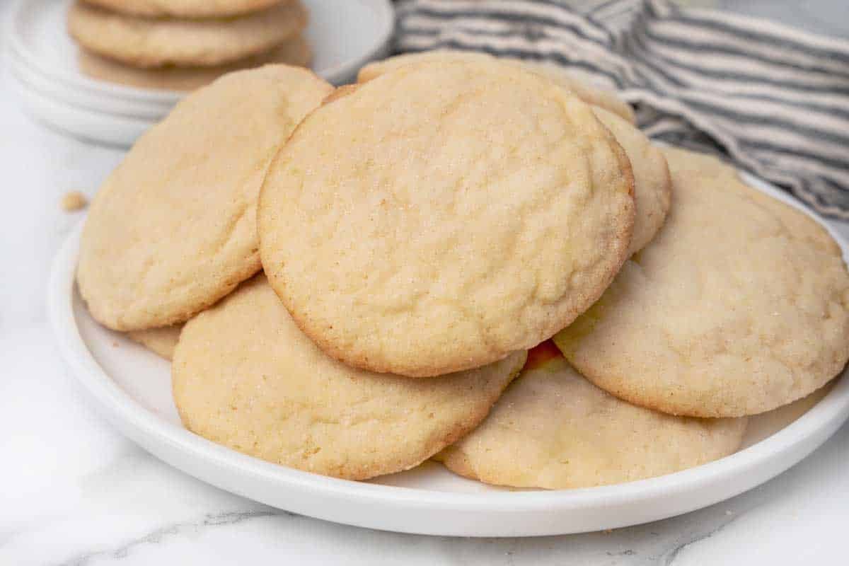 Pile of sugar cookies on a white plate