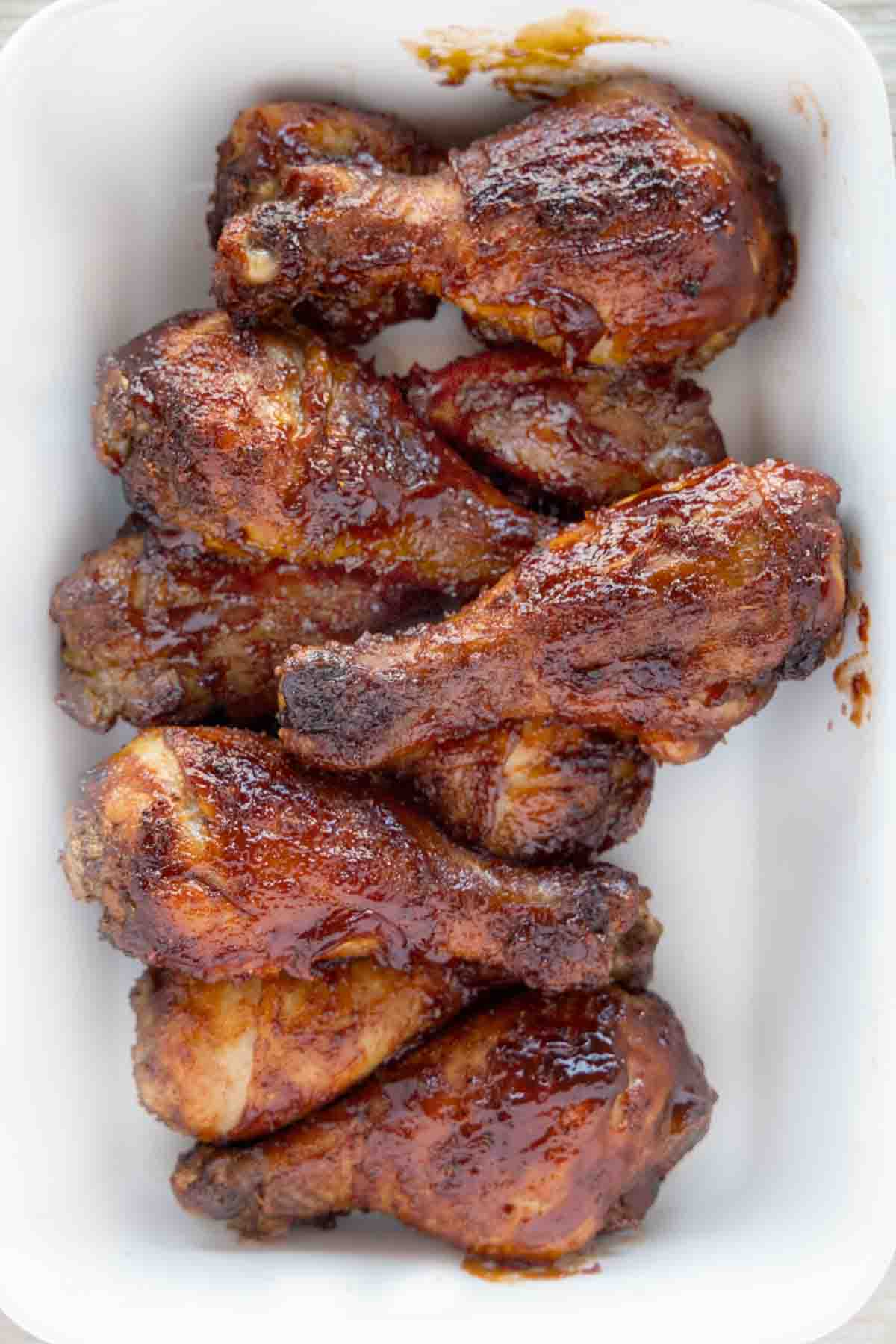 baked bbq chicken drumsticks on white platter