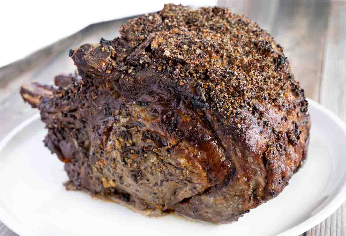 roasted prime rib roast on a white platter