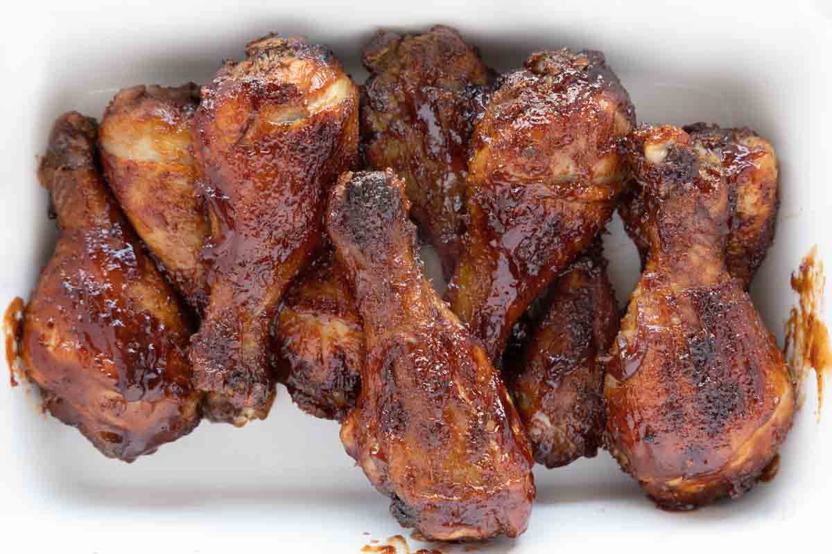 baked bbq chicken drumsticks on white platter