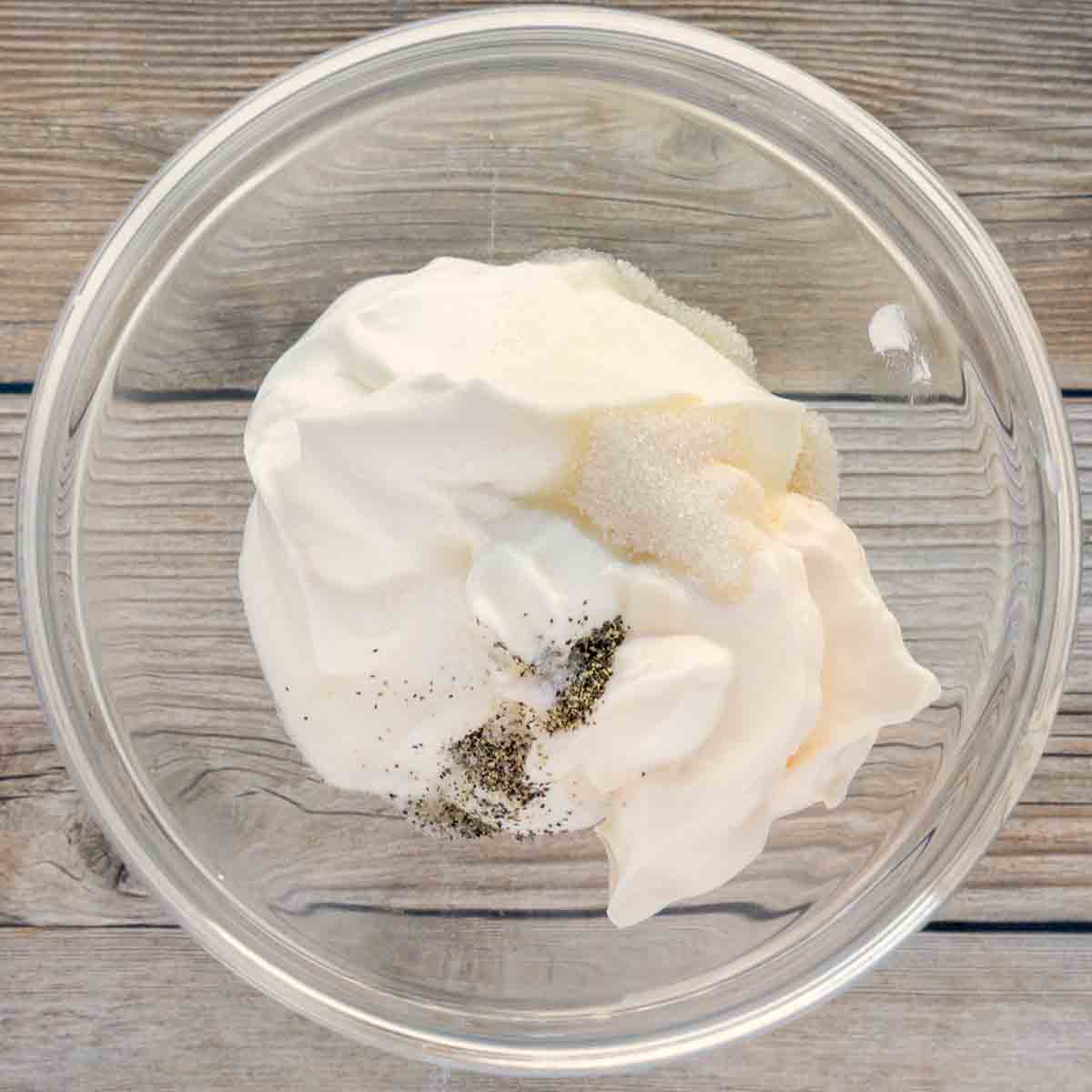 sour cream, mayonnaise and seasonings in glass bowl