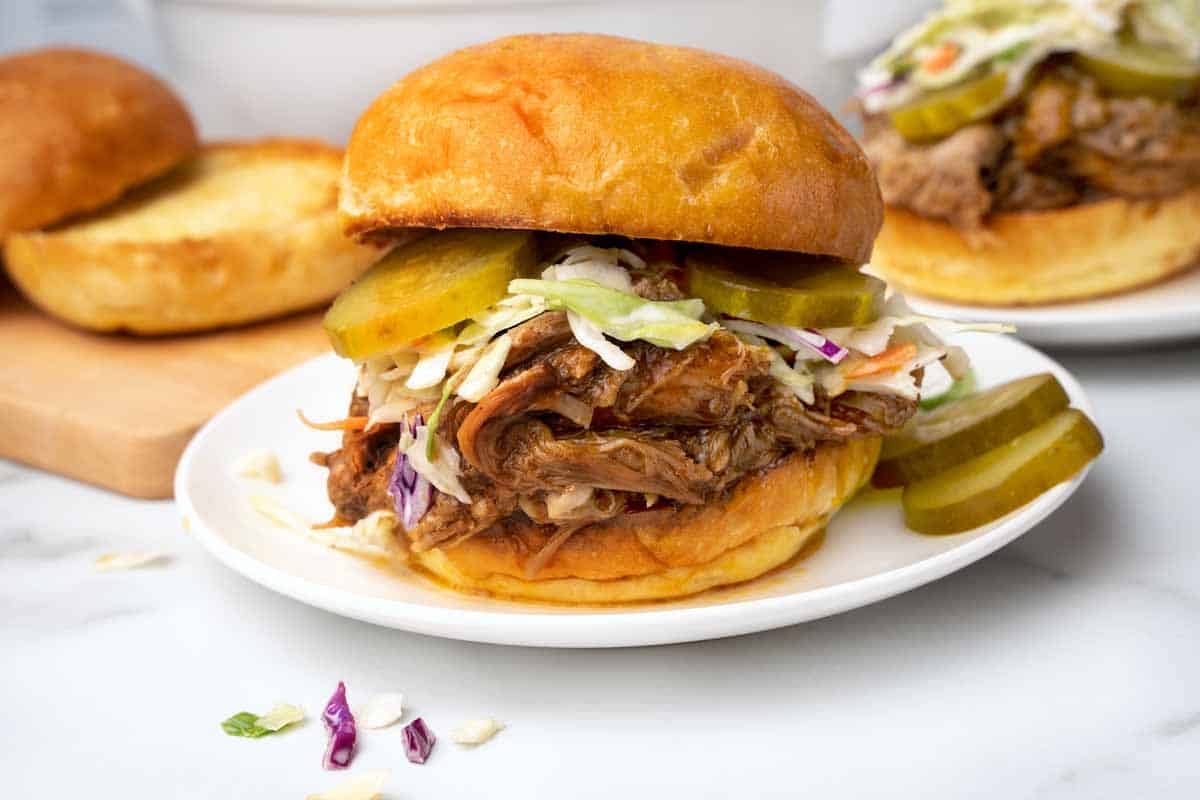 Texas pulled pork on a brioche bun with cole slaw and pickles.