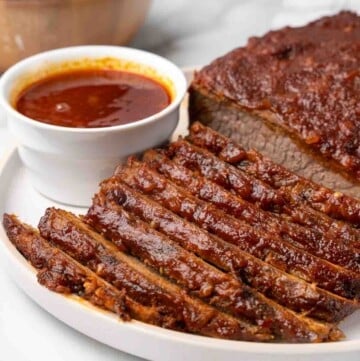 sliced barbecue beef brisket on white platter