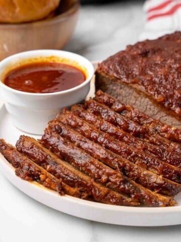 sliced barbecue beef brisket on white platter