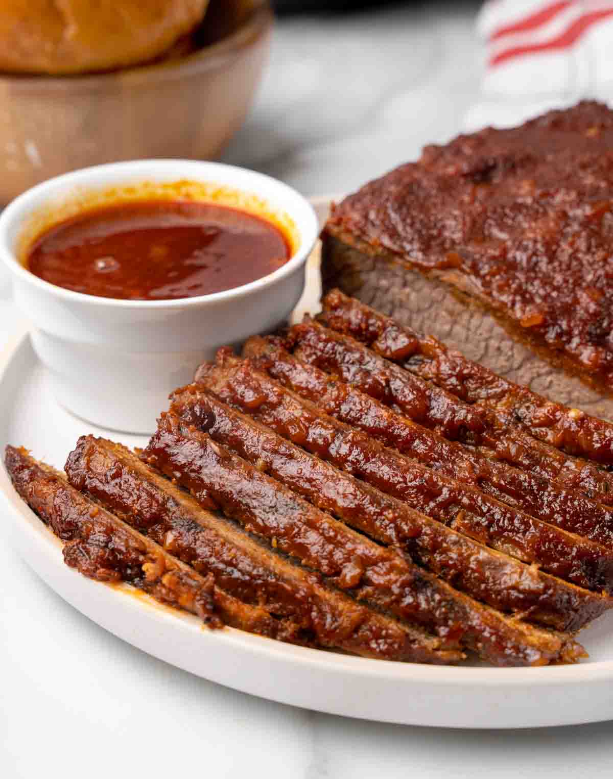 sliced barbecue beef brisket on white platter