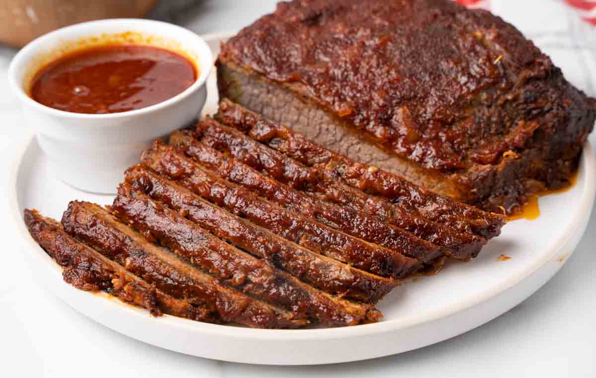 sliced barbecue beef brisket on white platter