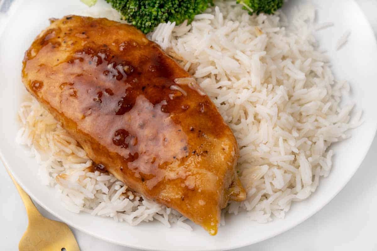 honey garlic chicken with white rice on a white plate