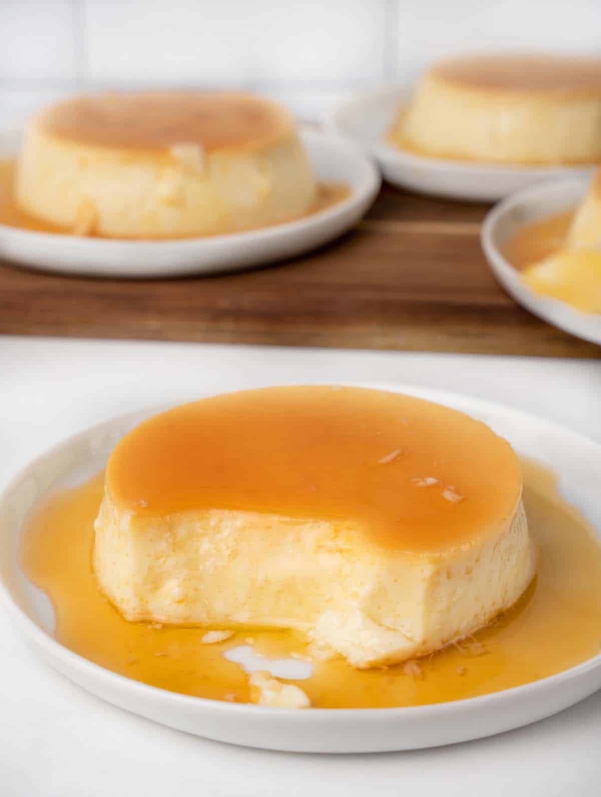 spanish flan on a white plate with caramel sauce 