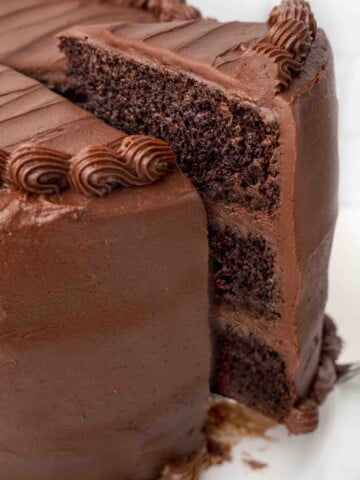 slice being taken out of a chocolate cake