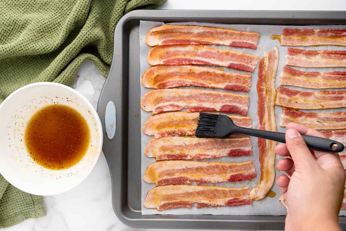 brushing mixture on bacon