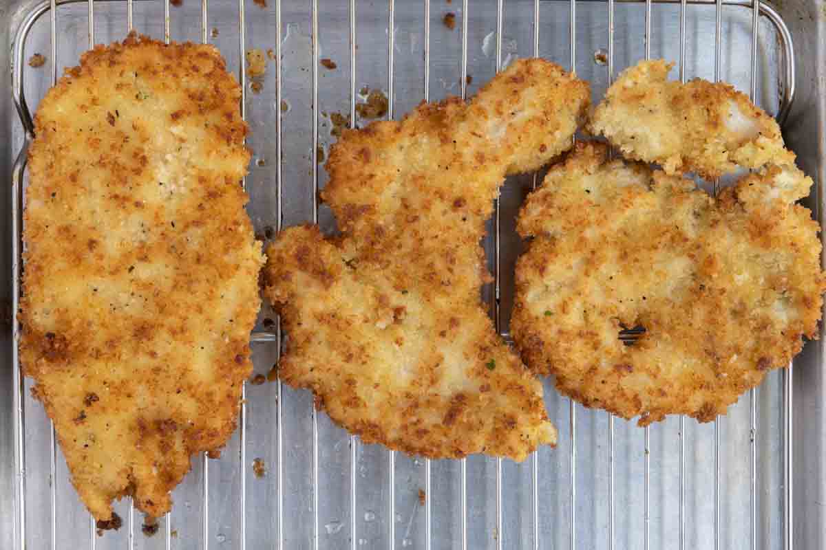 cooked breaded cutlets on a wire rack