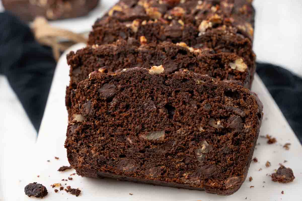 chocolate banana bread sliced on white platter