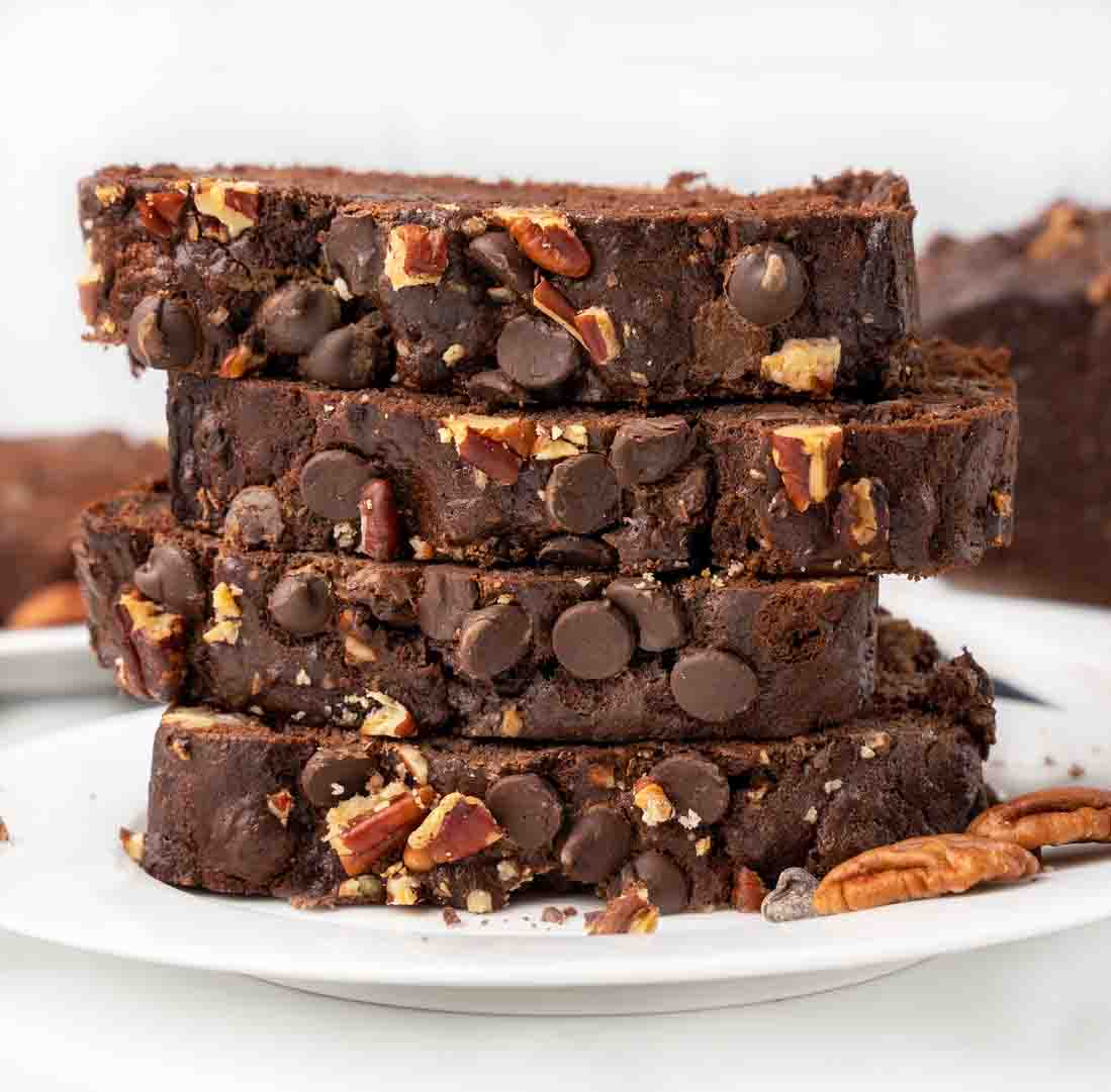 stack of chocolate banana bread slices on white plate