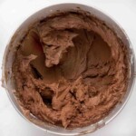 chocolate buttercream frosting in a metal mixer bowl.