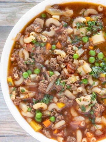 overhead view of hamburger soup in a white bowl