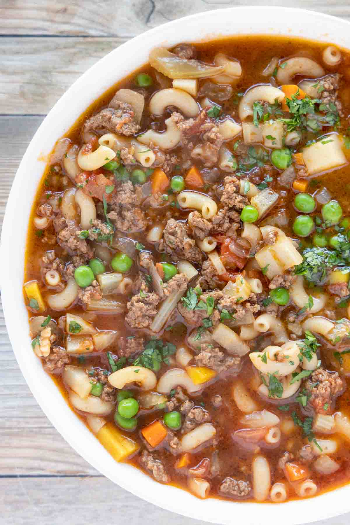 overhead view of hamburger soup in a white bowl