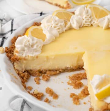 lemon cream pie with slices cut out.