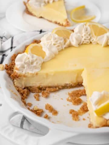 lemon cream pie with slices cut out.