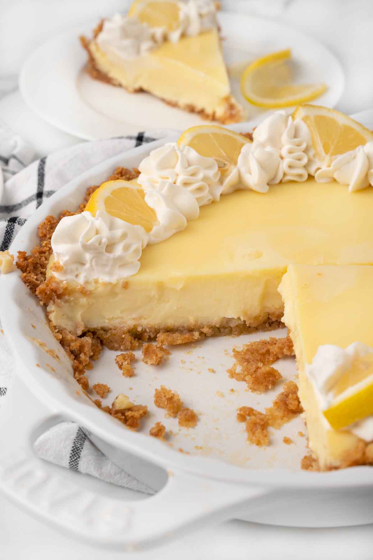 lemon cream pie with slices cut out.