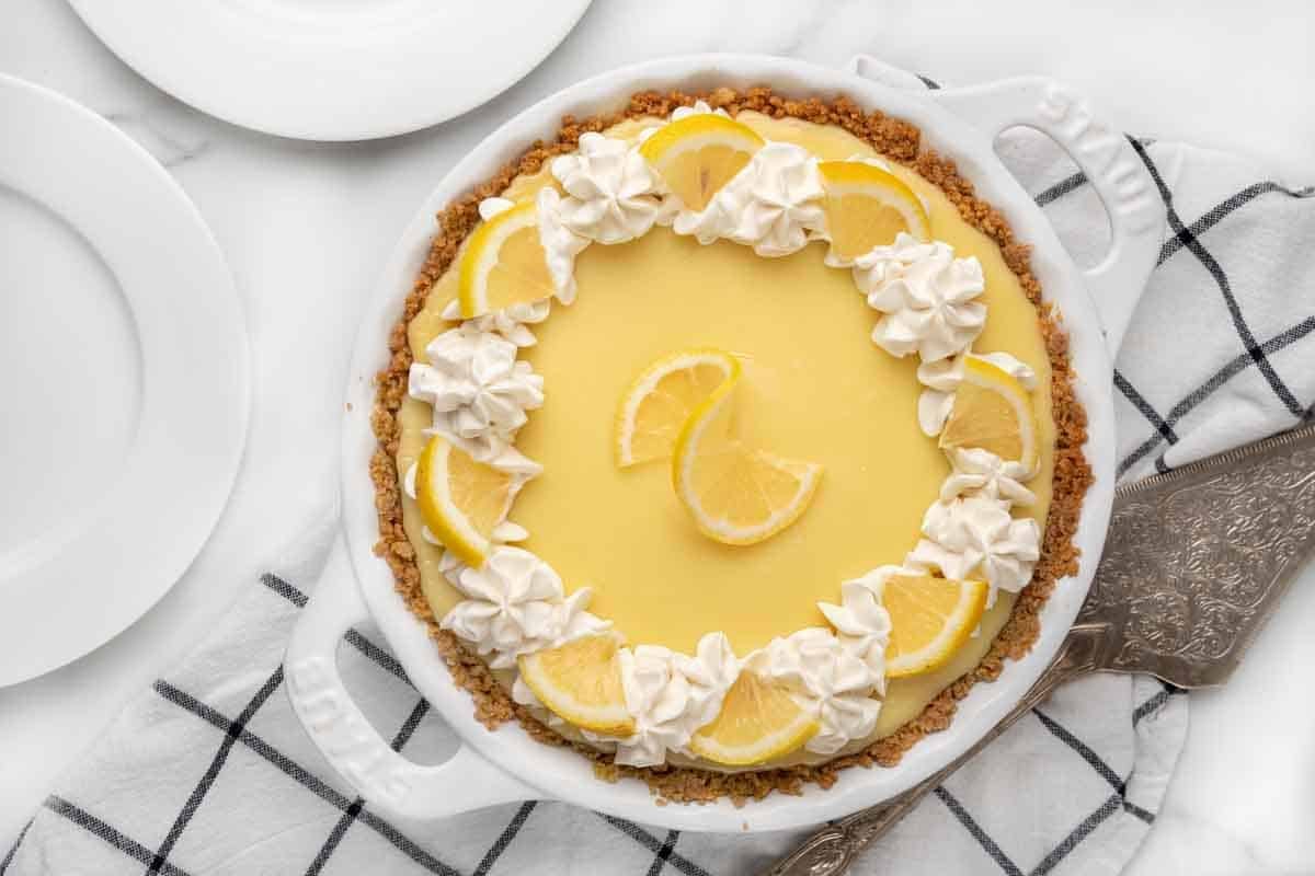 lemon cream pie in white pie pan