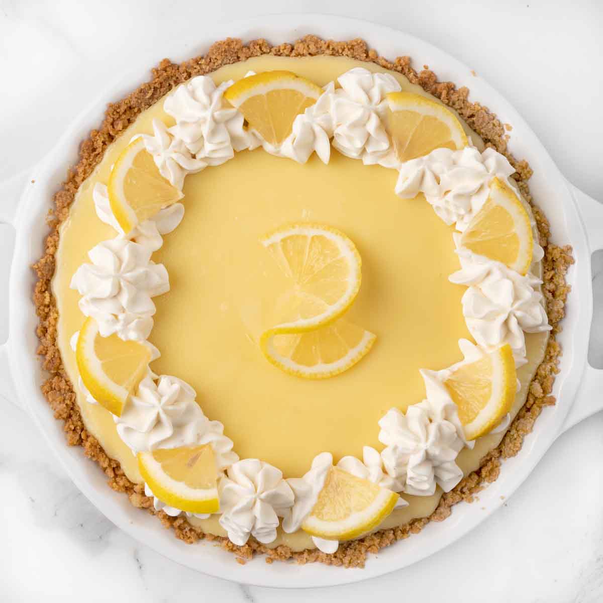 Lemon Cream pie with whipped cream and lemon slices