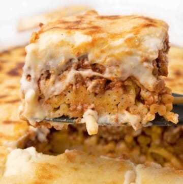piece of pastitsio being taken out of pan