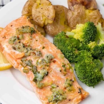 garlic butter salmon with broccoli and potatoes on a white plate