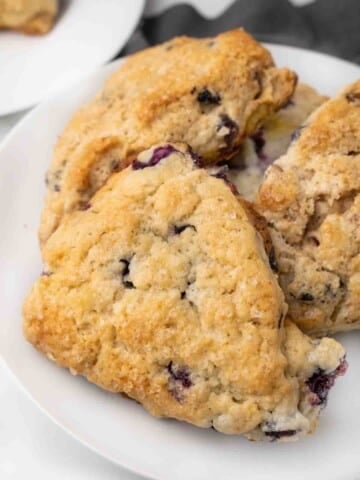 blueberry scones on a white platter.