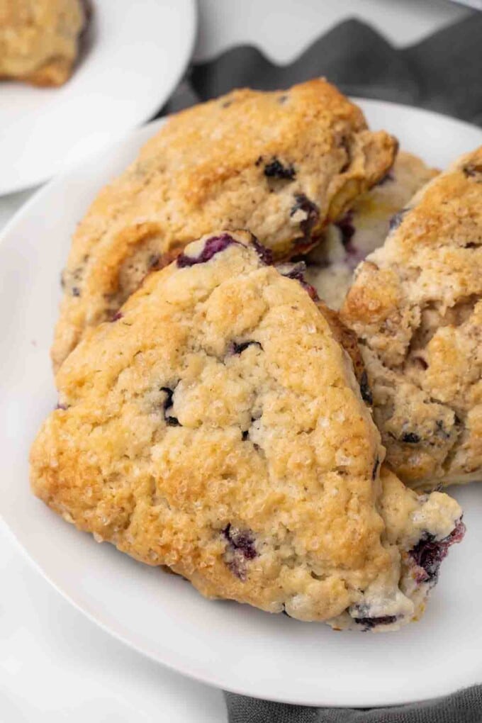 blueberry scones on a white platter.