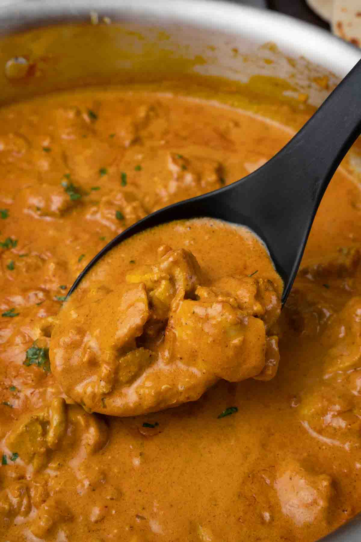 large black spoon in tikka masala